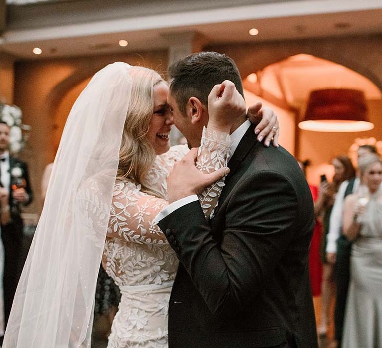 Bride & groom embrace during wedding ceremony at Hampton Manor 