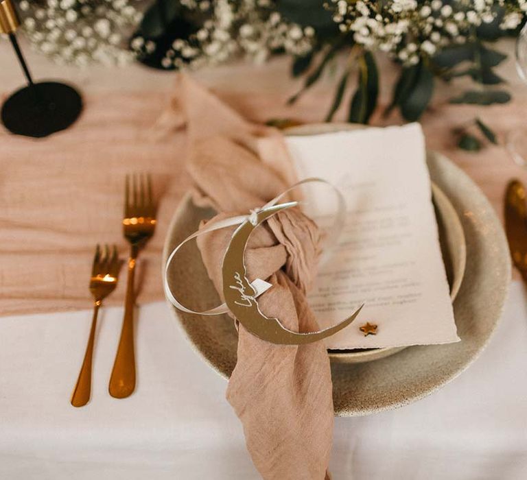 Wedding menu with neutral pink napkin and handmade golden moon napkin holder with rose gold cutlery