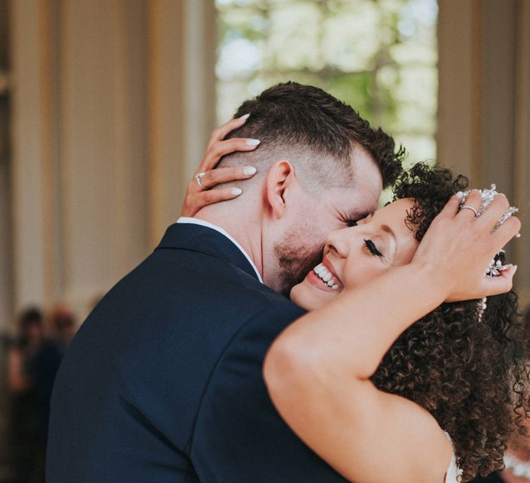 Bride & groom embrace lovingly during wedding ceremony at Orleans House Gallery