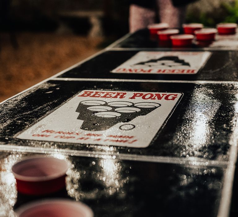 Black shiny beer pong table for the wedding games and entertainment at a gothic wedding in Dorset 