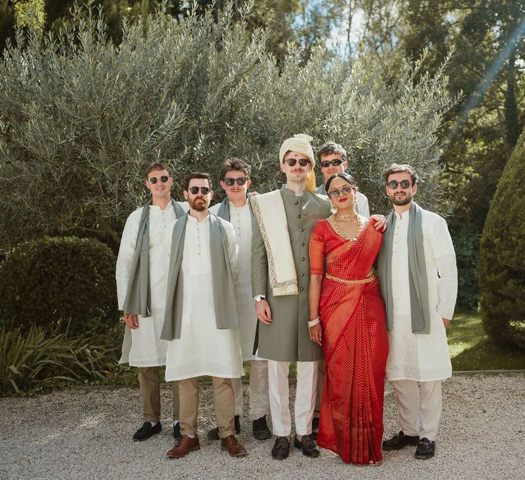 Bride in a red lehenga and groom in a green and cream Sherwani at destination Provence, Hindu wedding