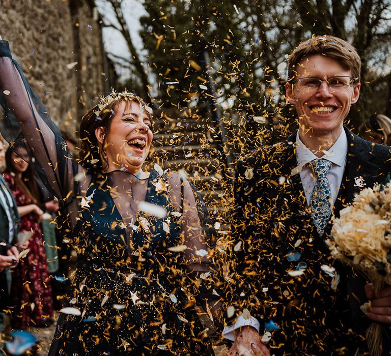 Dried yellow wedding confetti being thrown over the bride and groom as they exit from their civil ceremony 