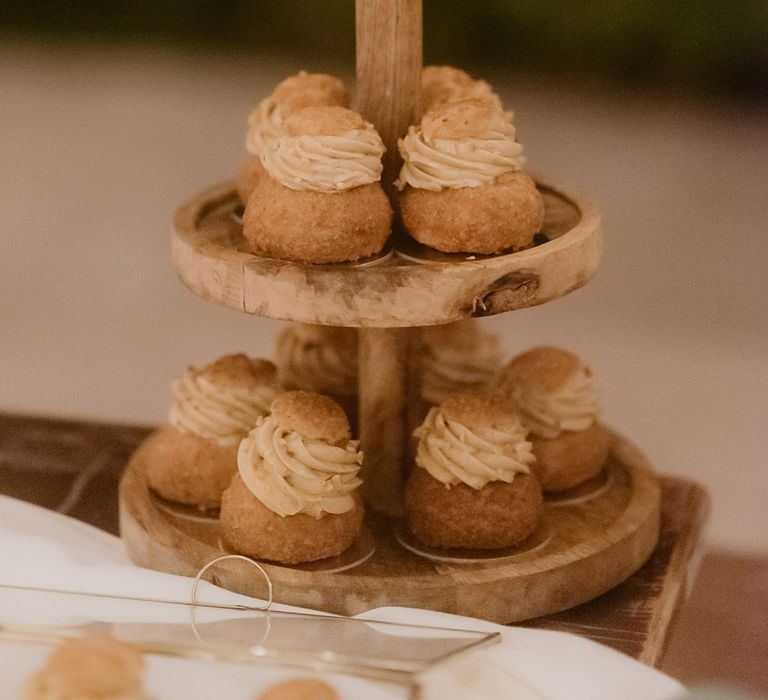 alternative wedding cake idea on wooden tier cake stand 