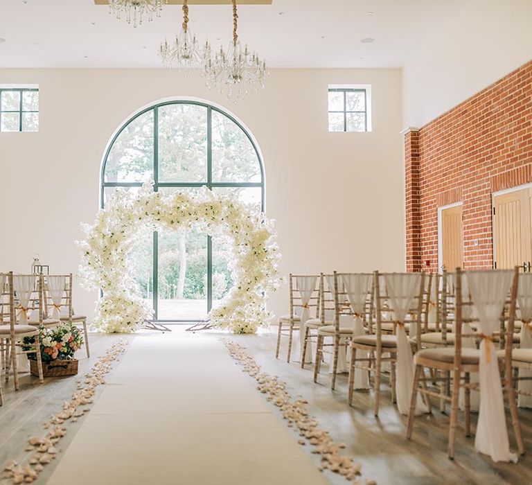 White floral heart shaped flower arch at the altar for classic wedding 