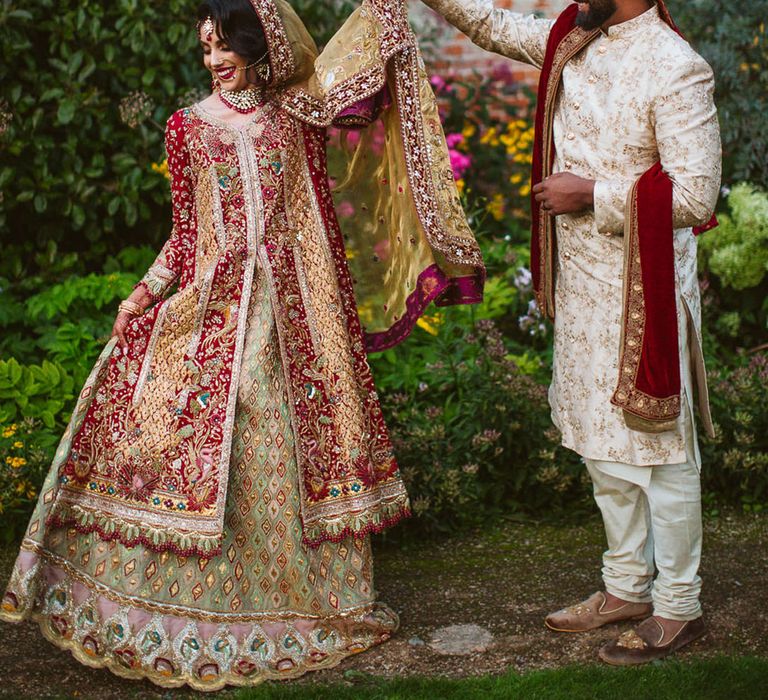 Bride and groom at Muslim wedding in deep jewel tone autumnal wedding outfits