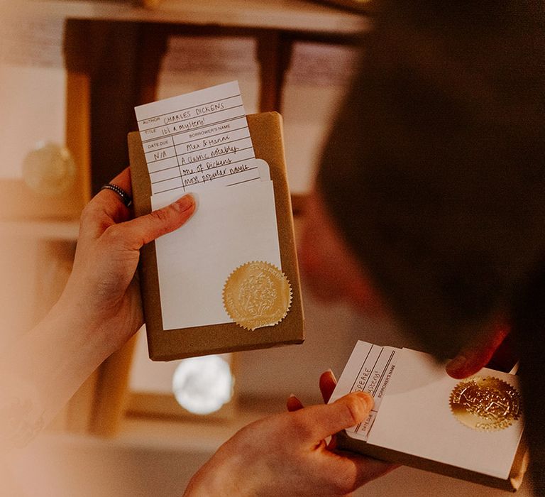 Guests pick up surprise wrapped books as their wedding favours 