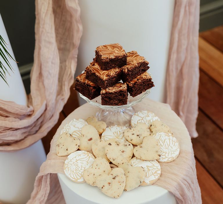 Heart shaped cookies and chocolate brownies on a plate for the wedding dessert station 