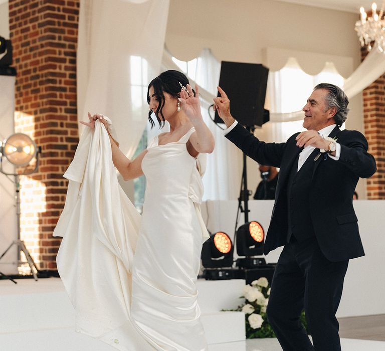 Father and daughter dance at wedding on custom dance floor 