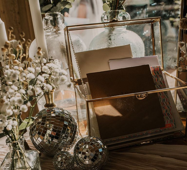 Wedding cards in glass box on table 