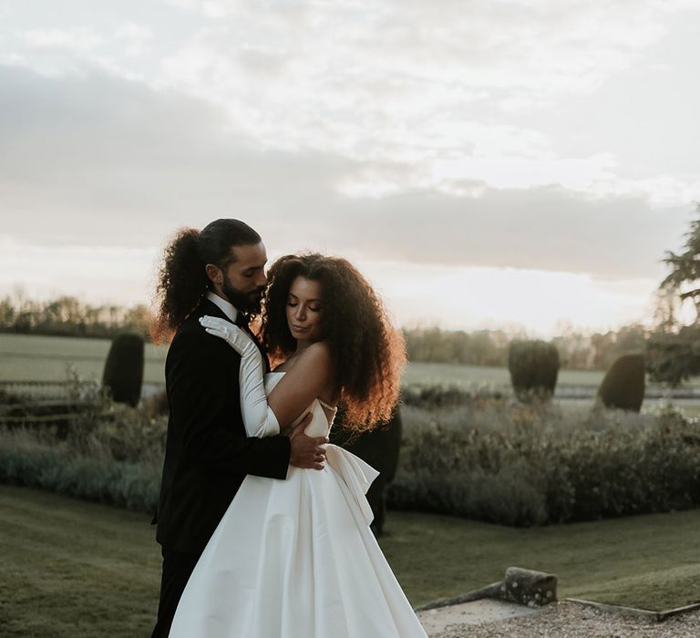 Bride and groom posing at golden hour for luxe country house wedding in Leicestershire 