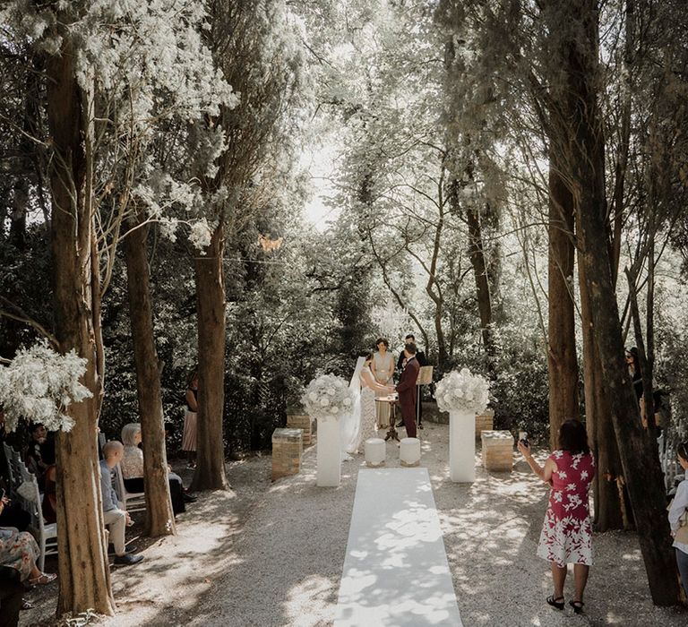 Luxe outdoor wedding ceremony in Italy with white wedding flowers 