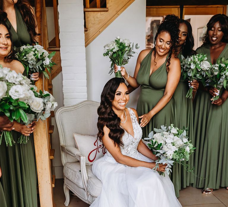 Bride wearing a classic princess wedding sress smiling with white rose bouquet 