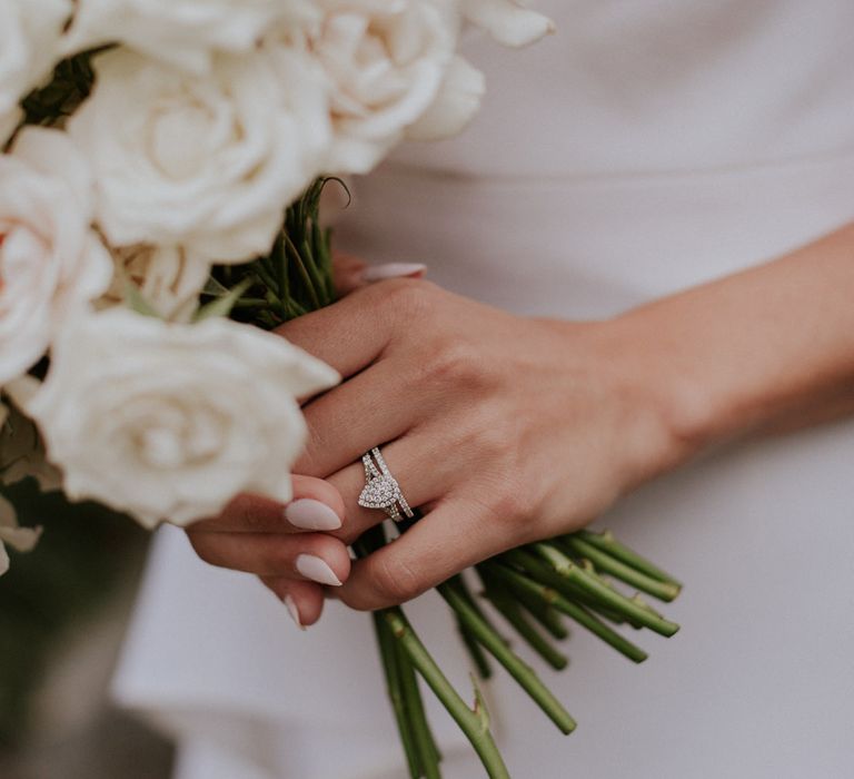 Diamond engagement ring and white rose bouquet 