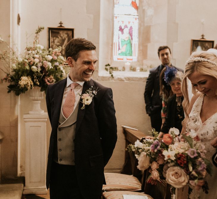 Emotional groom waiting at the altar for his bride 