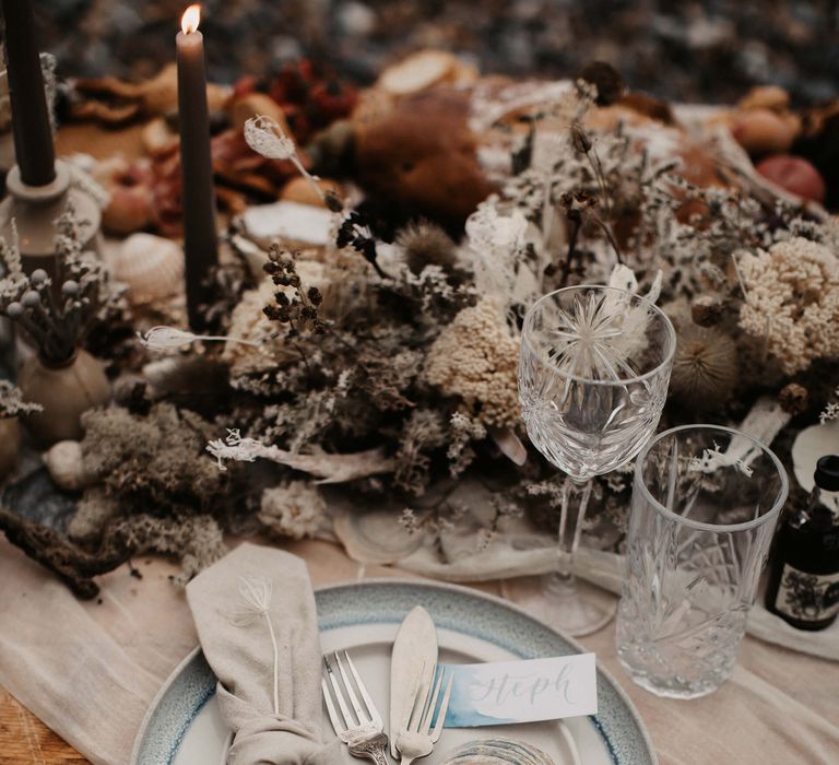 Place setting with cutlery tied in ribbon and shell wedding favour