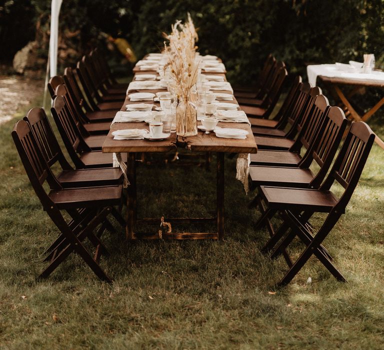 Rustic wedding table and chairs with dried flower centrepieces 