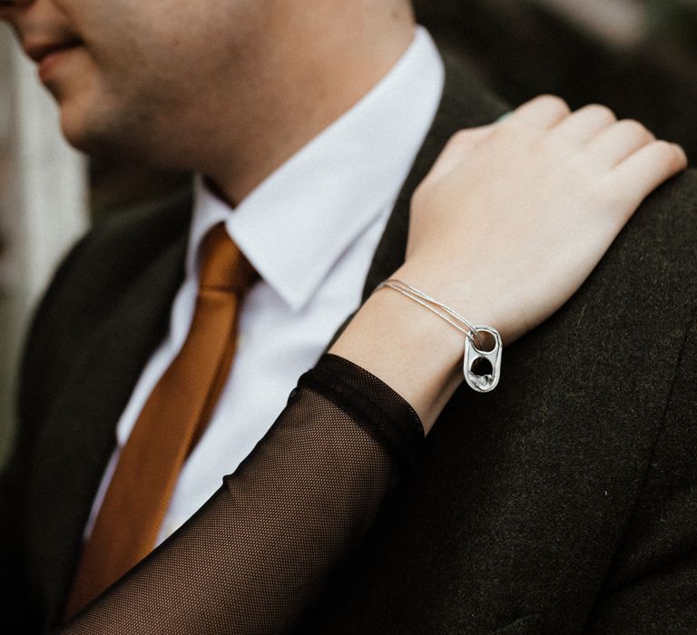 Bride wears ring pull from can as a bracelet and engagement ring