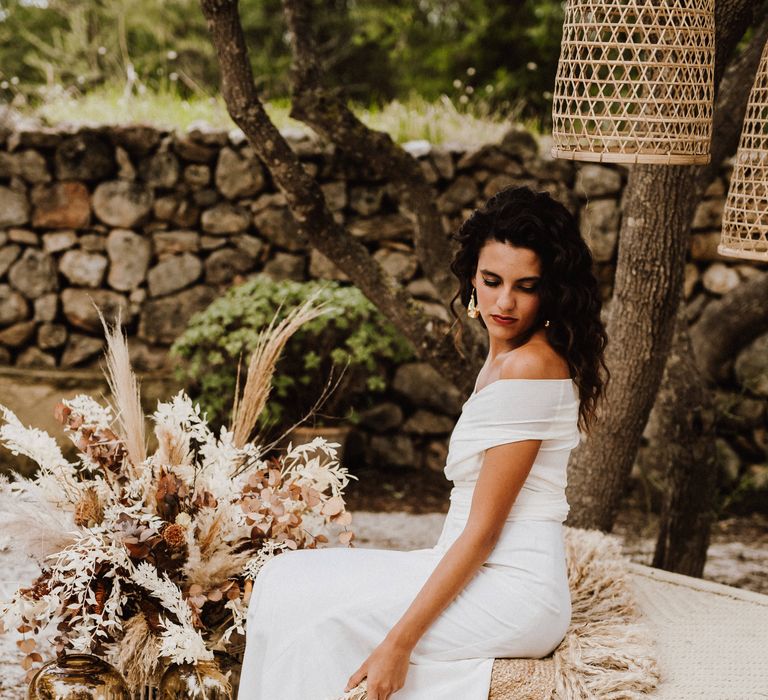 Bride wearing off the shoulder white bridal gown