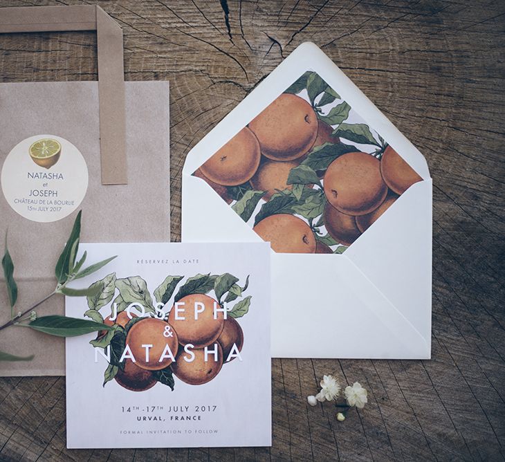 Oranges inspired French wedding stationery with orange print on the inside of the envelope.