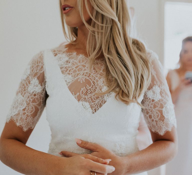 Bride in white Charlie Brear wedding dress and white Augusta Jones lace top at Caswell House wedding