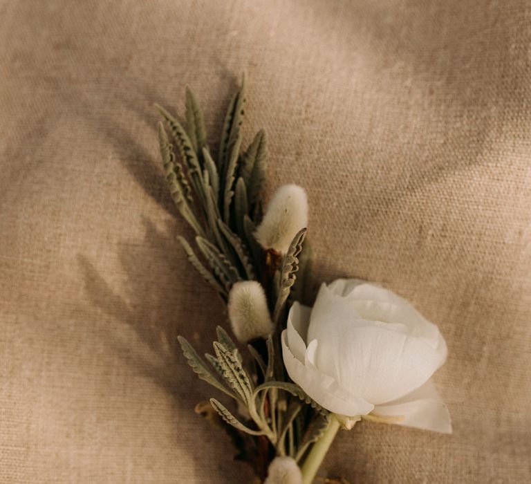 Delicate white buttonhole flower 