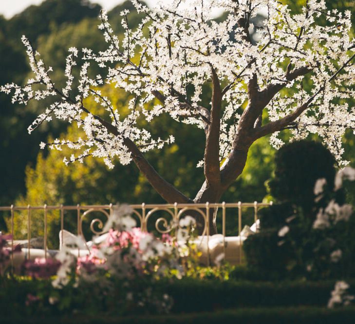 Cherry blossom decor and daybed at wedding - Image courtesy of Marble Private