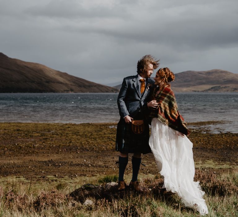 Bride & groom kiss with the sea in the background for Isle of Skye elopement