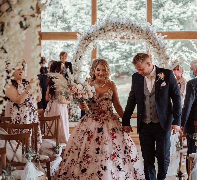 Bride & groom walk down the aisle after wedding ceremony