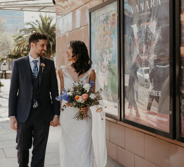 Bride and groom walking through Hackney