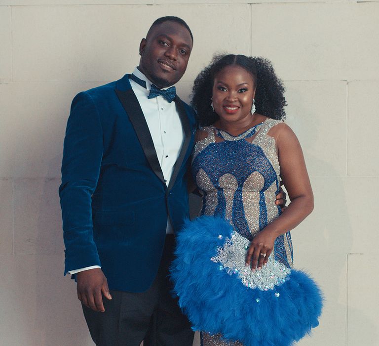 Bride & groom wear formal wear at the end of their wedding with accent blue colour