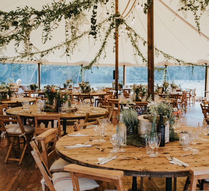 Stretch tent bohowedding reception with foliage wedding decor 