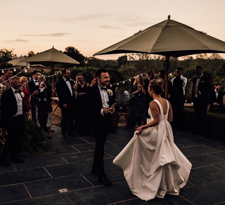 Bride & groom dance outside as the sun sets during their English country wedding