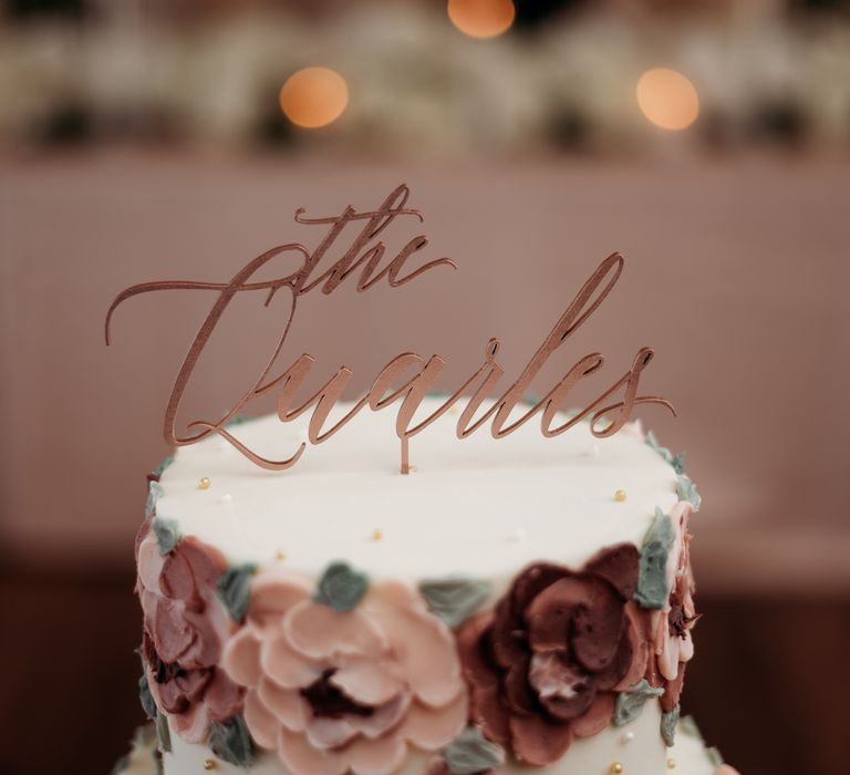 White frosted wedding cake with frosted flowers 