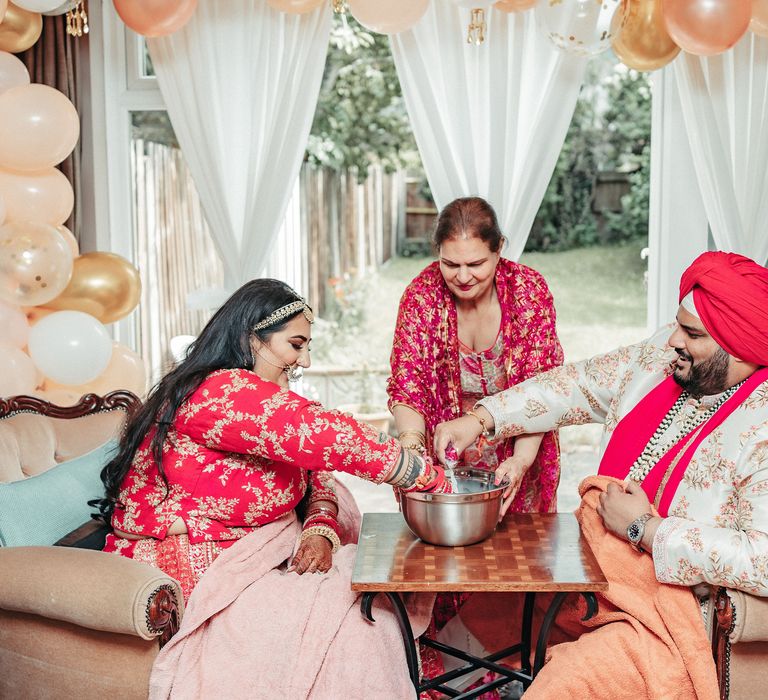 Bride & groom sit opposite one another on the day of their wedding