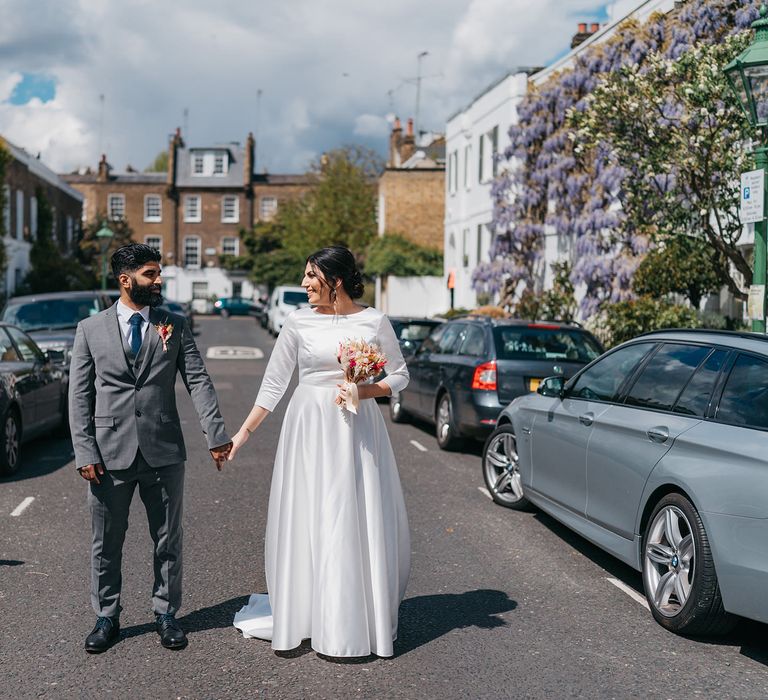 Bride & groom walk through the streets of Chelsea as the sun shines