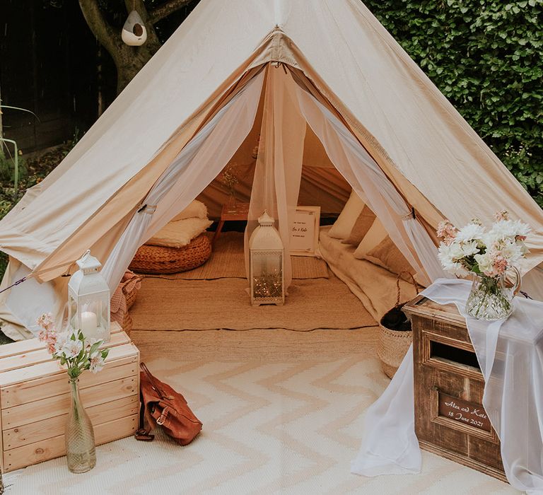 Bell tent seating area at back garden wedding reception 