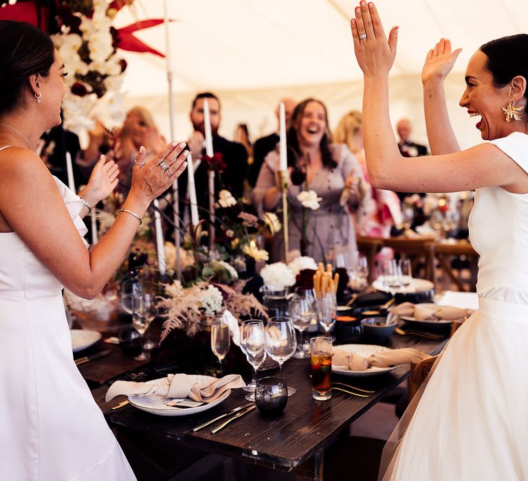 Bride cheers with wedding guests