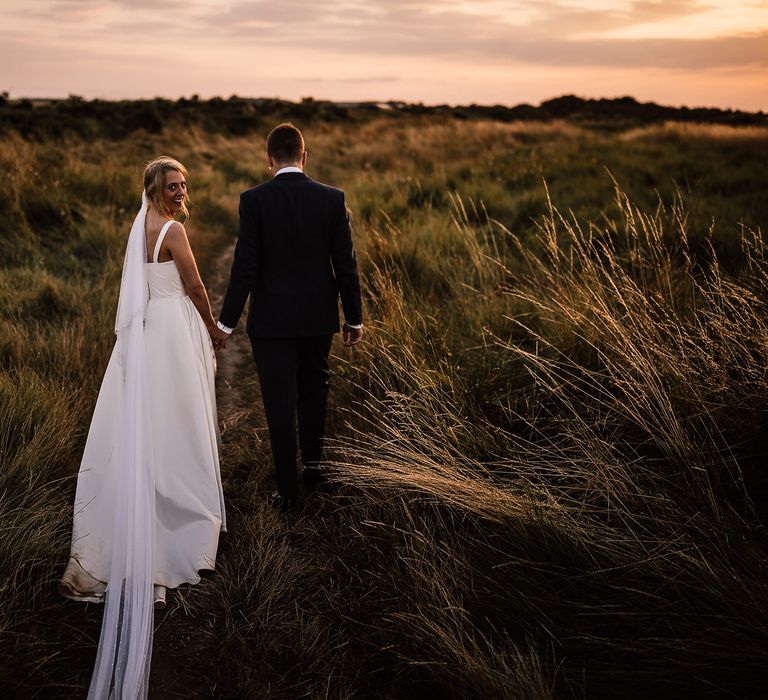 Bride and groom in sunset portrait at garden wedding