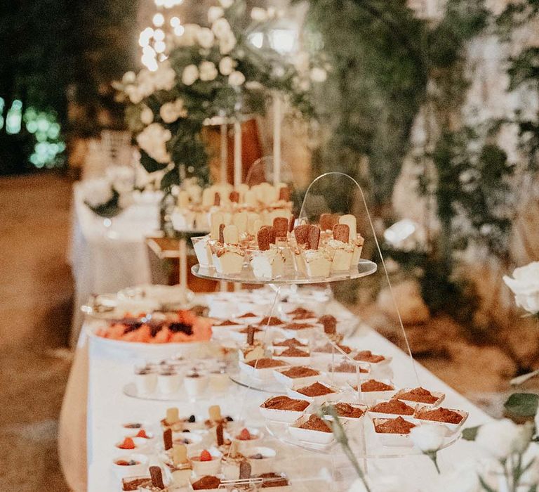 Table lined with white linen cloth filled with canapés  | Royal Studio