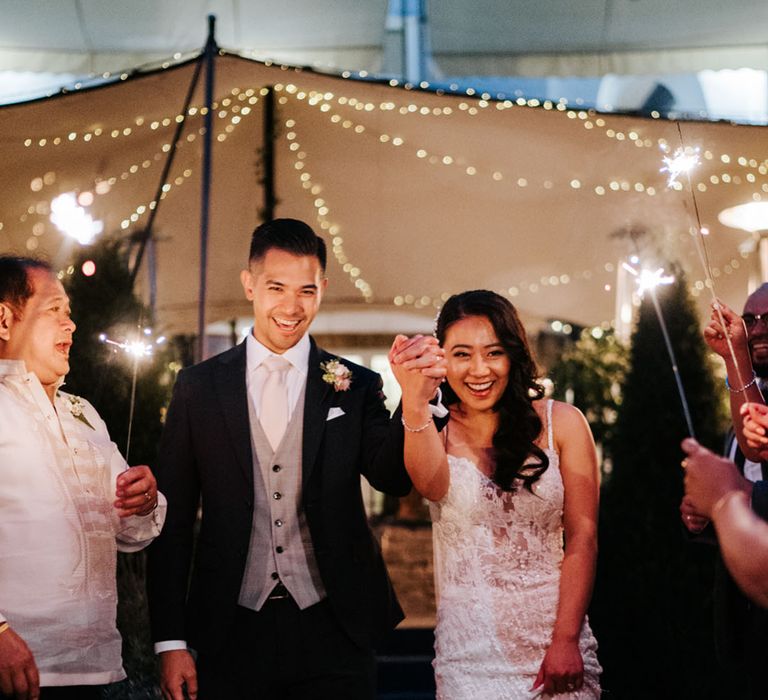 Confetti moment with South Asian bride in a sparkly wedding dress and groom in a three-piece suit at their Bingham Riverhouse wedding 