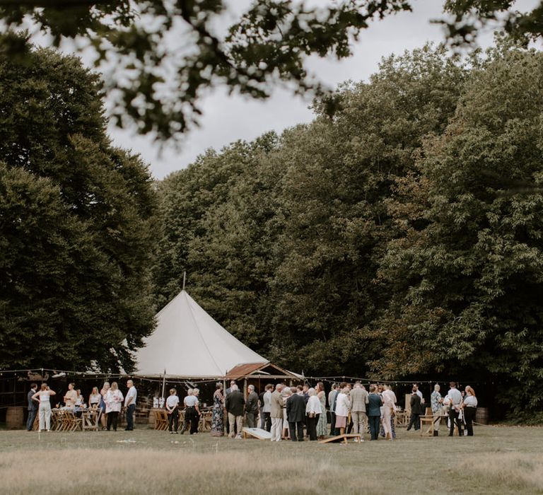 Tipi outdoors in field for woodland wedding