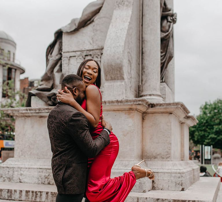 Groom lifts bride outdoors in Manchester 