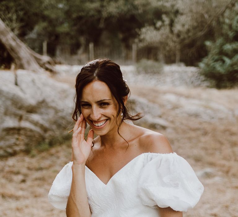 Smiling bride in Alexandra Grecco dress