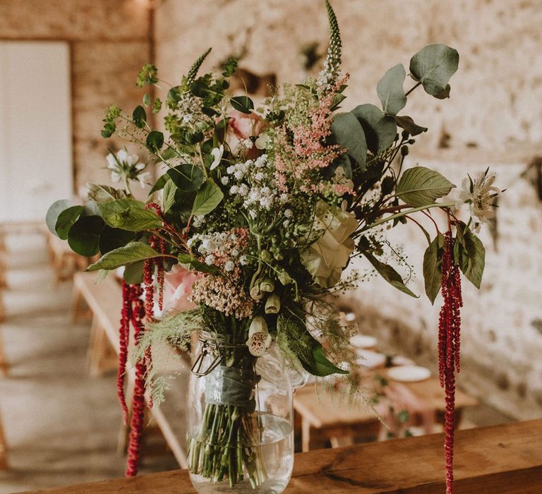 Wedding bouquet including pink roses, white gypsophila and leaves