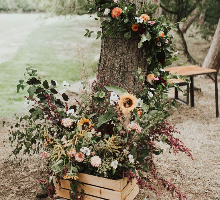 Wedding flowers wrap around trees for wedding decoration at the outdoor woodland wedding ceremony 