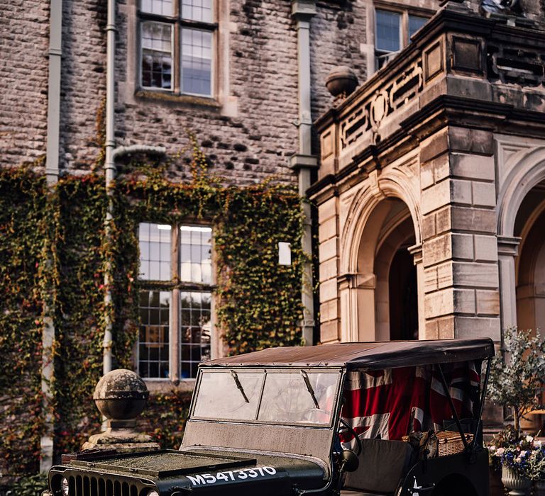 Jeep wedding car transport with a flag of Great Britain outside of Callow Hall