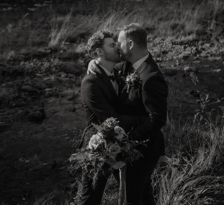 Grooms share a kiss for their couple portraits taken by LGBTQ photographer Esme Whiteside Photography