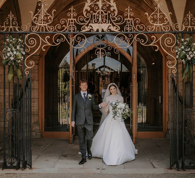 Bride and groom exit the cathedral after their wedding ceremony 