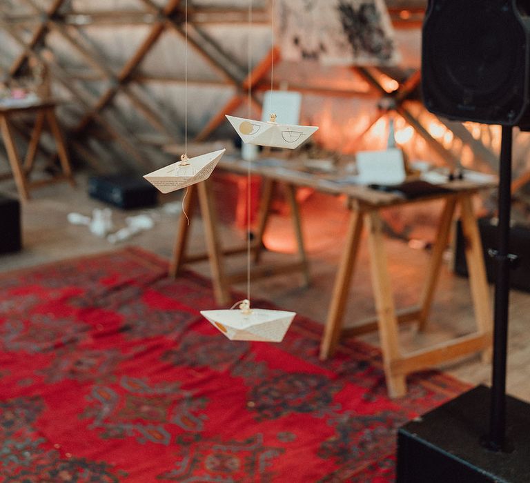 DIY paper wedding boat decoration made from old books hanging down 