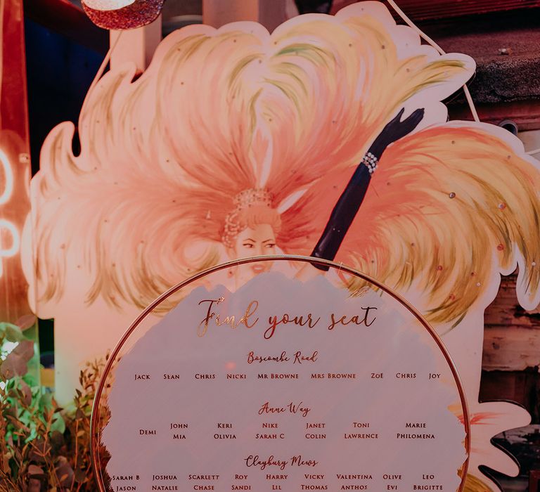 Circular wedding table plan with gold calligraphy 